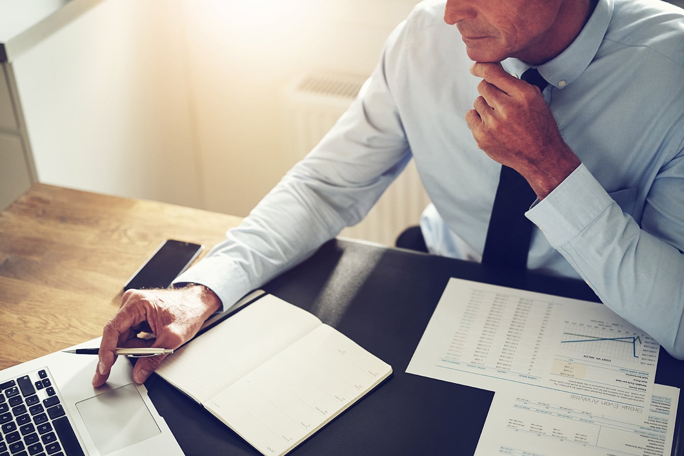 Financial Planner Working Online At A Desk In An Office